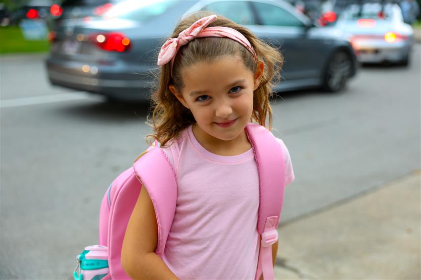 Students smile on the first day of kindergarten